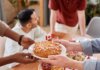 Пьер Пуальевр требует от Карни «хорошей сделки» с США A group of people sharing a pie with a Canadian flag, symbolizing unity and celebration.