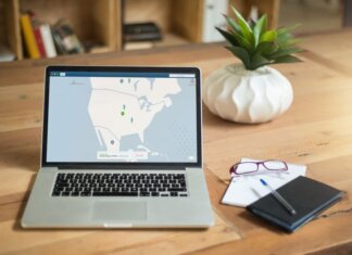 A laptop displaying VPN software sits on a wooden desk with a notepad and plant offering a secure workspace vibe.