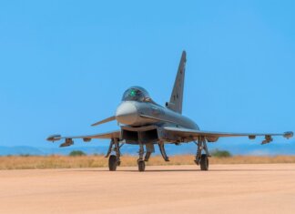 Беспилотные самолёты для самых труднодоступных мест Канады A military jet fighter on the runway ready for takeoff against a bright blue sky.