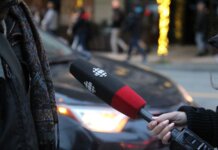 CBC отказалась называть теракты 11 сентября терактами A person being interviewed on a Vancouver street, holding a microphone.