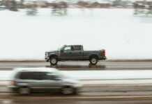 A pickup truck speeds through a snowy highway in Calgary, capturing motion and winter ambiance.