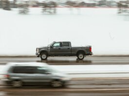 A pickup truck speeds through a snowy highway in Calgary, capturing motion and winter ambiance.