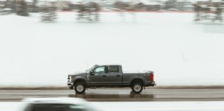 A pickup truck speeds through a snowy highway in Calgary, capturing motion and winter ambiance.