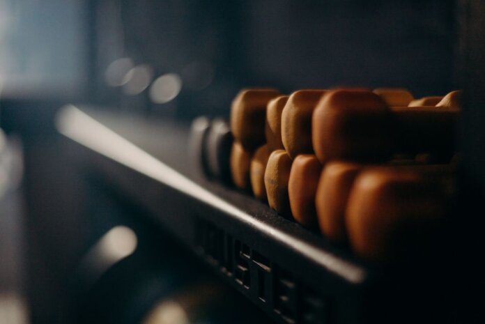 A rack of dumbbells in a dimly lit gym, highlighting fitness equipment. A rack of dumbbells in a dimly lit gym, highlighting fitness equipment.