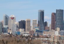 A stunning view of Calgary's skyline featuring the iconic Calgary Tower against a clear sky.