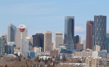 A stunning view of Calgary's skyline featuring the iconic Calgary Tower against a clear sky.