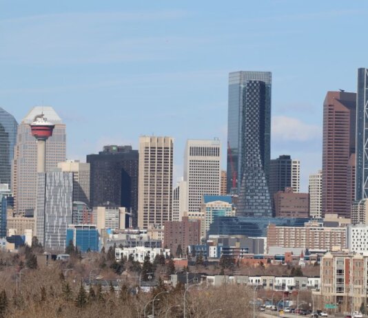 A stunning view of Calgary's skyline featuring the iconic Calgary Tower against a clear sky.