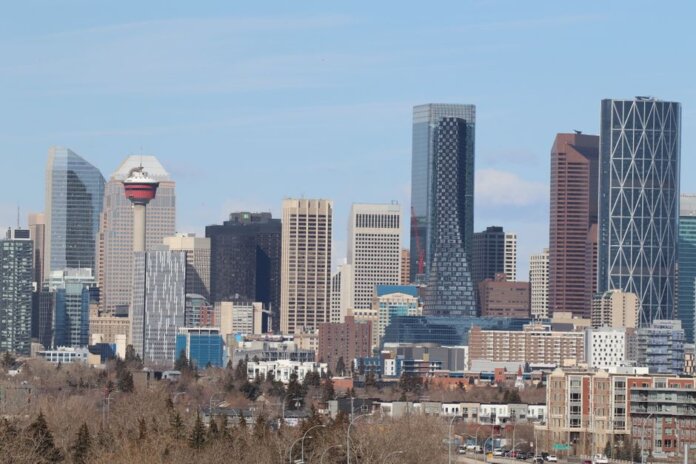 A stunning view of Calgary's skyline featuring the iconic Calgary Tower against a clear sky.