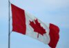 A vibrant Canadian flag fluttering in the wind, symbolizing national pride.
