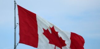 A vibrant Canadian flag fluttering in the wind, symbolizing national pride.