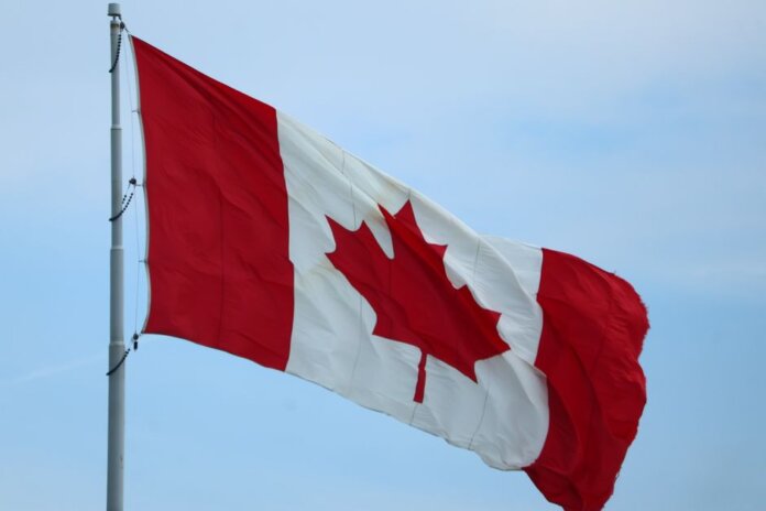 A vibrant Canadian flag fluttering in the wind, symbolizing national pride.