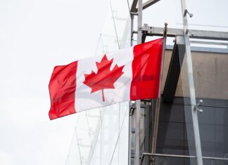 Канада примет участие в «Евровидении-2027» A vibrant Canadian flag waving on a clear day, representing patriotism and national pride.