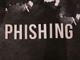 Abstract representation of phishing with the text on a textured dark surface.