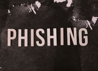 Abstract representation of phishing with the text on a textured dark surface.
