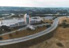 Aerial shot of the Confederation Building in Newfoundland with surrounding landscape and roads.
