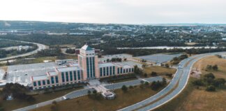 Aerial shot of the Confederation Building in Newfoundland with surrounding landscape and roads.