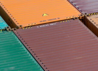 Aerial view of vibrant cargo containers arranged in a pattern, emphasizing logistics and transportation.