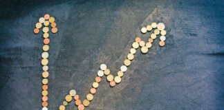 An upward trend graph made from coins representing financial growth and success.