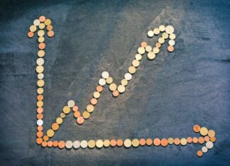 An upward trend graph made from coins representing financial growth and success.