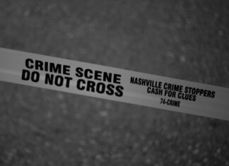 Black and white close-up of crime scene tape with Nashville text.