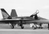 Canadian fighter jet on airstrip. Monochrome image showcasing aviation and military theme.