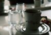 TransLink и Trees выпустили фирменный кофе и чай для пассажиров Close-up of a floral coffee cup and water glass on a table setting.