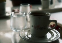 TransLink и Trees выпустили фирменный кофе и чай для пассажиров Close-up of a floral coffee cup and water glass on a table setting.