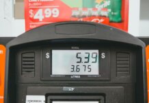 Close-up of a gas pump display showing price per liter and total volume during a transaction.
