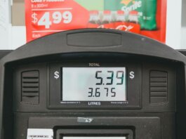 Close-up of a gas pump display showing price per liter and total volume during a transaction.