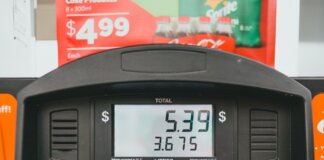 Close-up of a gas pump display showing price per liter and total volume during a transaction.