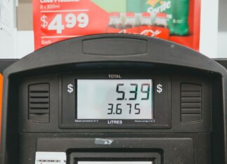 Close-up of a gas pump display showing price per liter and total volume during a transaction.