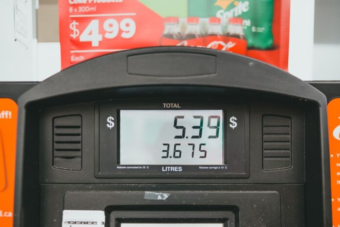 Close-up of a gas pump display showing price per liter and total volume during a transaction.