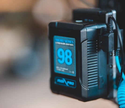 Close-up of a high-capacity portable battery with digital display showing 98 percent charge.