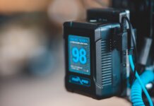 Close-up of a high-capacity portable battery with digital display showing 98 percent charge.