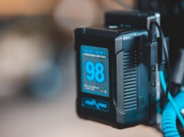 Close-up of a high-capacity portable battery with digital display showing 98 percent charge.