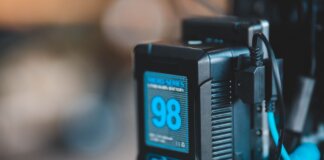 Close-up of a high-capacity portable battery with digital display showing 98 percent charge.