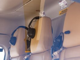 Close-up of a luxurious helicopter interior with leather seats and headphones.