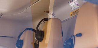 Close-up of a luxurious helicopter interior with leather seats and headphones.