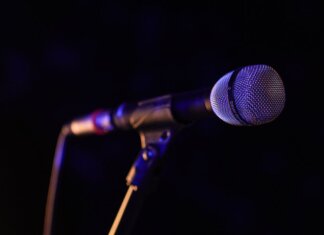 Close-up of a microphone set up on stage, highlighting concert ambiance.