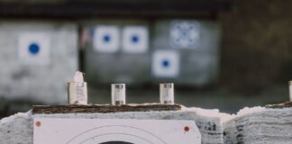 Close-up of archery targets and steel cans used for target practice at an outdoor range.