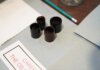 Консерваторы: риторика Карни не соответствует экономической реальности Close-up of film negatives and tools used in vintage photography development.
