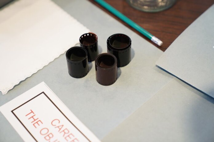 Close-up of film negatives and tools used in vintage photography development. Close-up of film negatives and tools used in vintage photography development.