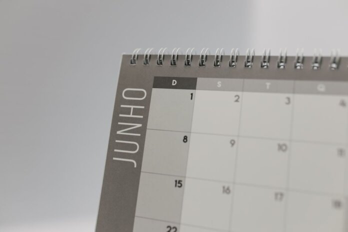 Close-up view of a spiral-bound calendar showing the month of June with a date grid. Close-up view of a spiral-bound calendar showing the month of June with a date grid.