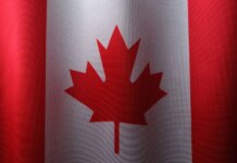 Close-up view of the Canadian flag with its iconic red maple leaf.