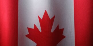 Close-up view of the Canadian flag with its iconic red maple leaf.