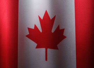 Close-up view of the Canadian flag with its iconic red maple leaf.