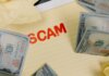 Conceptual image of financial scam with US dollars on yellow paper and word 'scam' visible.