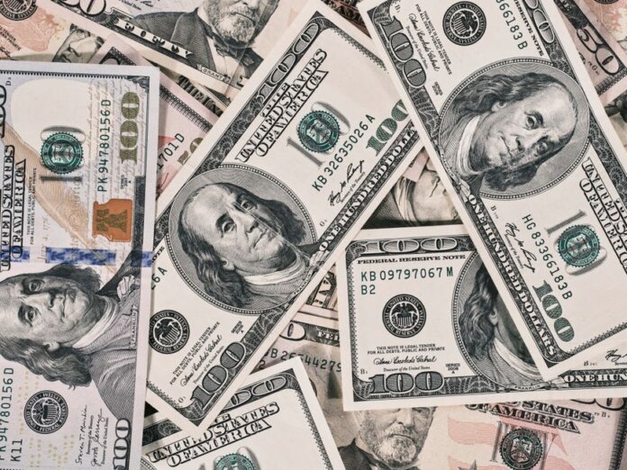 Detailed close-up of US dollar bills highlighting wealth and finance concepts. Detailed close-up of US dollar bills highlighting wealth and finance concepts.