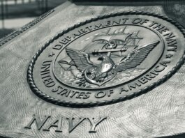 Detailed view of the United States Navy emblem on a monument in Washington D.C., showcasing naval heritage.