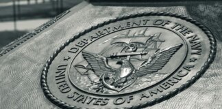 Detailed view of the United States Navy emblem on a monument in Washington D.C., showcasing naval heritage.
